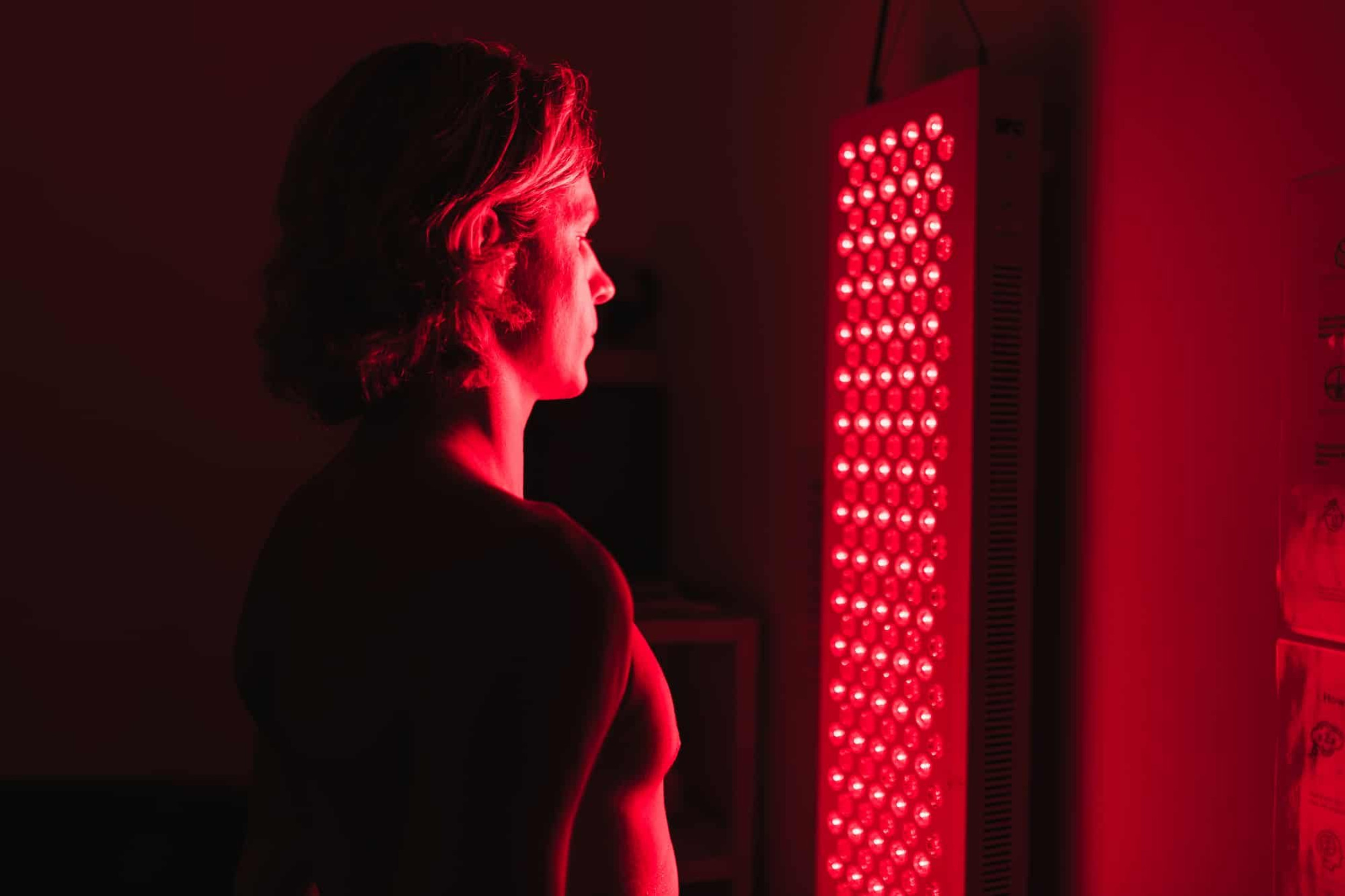 Man using a red light therapy device